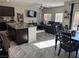 Bright living and dining area with an open view to the kitchen and a comfortable seating arrangement at 6867 Dragonfly Rock St, Las Vegas, NV 89148