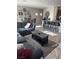 Open-concept living room with comfortable seating, a dining area, and barstool seating at the kitchen counter at 6867 Dragonfly Rock St, Las Vegas, NV 89148