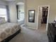 Bedroom with an en suite bath, closet, carpeted floors, and a comfortable king size bed at 6867 Dragonfly Rock St, Las Vegas, NV 89148