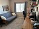Home office space with a futon, desk, and natural light from a window at 6867 Dragonfly Rock St, Las Vegas, NV 89148