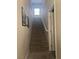 Carpeted staircase leading to the upper level with natural light from a window at 6867 Dragonfly Rock St, Las Vegas, NV 89148