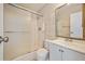 Bathroom featuring a shower-tub combo with glass doors, vanity with sink, and neutral tile at 745 N Royal Crest Cir # 157, Las Vegas, NV 89169