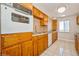 This classic kitchen features wood cabinetry, tile floors, and integrated appliances for a cozy cooking space at 745 N Royal Crest Cir # 157, Las Vegas, NV 89169