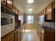 Galley kitchen offers wooden cabinets, tiled countertops, white appliances, and natural lighting at 745 N Royal Crest Cir # 157, Las Vegas, NV 89169