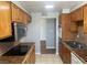 Traditional kitchen features wooden cabinets, tiled countertops and backsplash, and stainless steel microwave at 745 N Royal Crest Cir # 157, Las Vegas, NV 89169