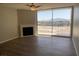 Bright living room with wood floors, fireplace, ceiling fan, and sliding glass doors at 745 N Royal Crest Cir # 157, Las Vegas, NV 89169