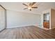 Bright living room featuring light wood floors, a wet bar, and sliding glass doors to a balcony at 745 N Royal Crest Cir # 157, Las Vegas, NV 89169