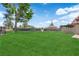 Expansive backyard features lush lawn and mature trees at 781 Bourbon St # 1, Pahrump, NV 89048