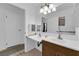 Bathroom with double sinks, updated fixtures, and a large mirror with decorative lighting at 781 Bourbon St # 1, Pahrump, NV 89048