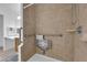 Accessible bathroom showcasing a tiled shower with grab bars and a built-in seat for comfort at 781 Bourbon St # 1, Pahrump, NV 89048