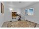 Bright bedroom with a large window, neutral walls, and a cozy reading nook with a lamp at 781 Bourbon St # 1, Pahrump, NV 89048