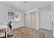 Cozy bedroom featuring a window, closet, and a tile floor covered with a patterned rug at 781 Bourbon St # 1, Pahrump, NV 89048