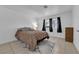 Inviting bedroom with a large window and neutral tones, complete with tiled flooring and a modern rug at 781 Bourbon St # 1, Pahrump, NV 89048
