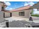 Side exterior view of a home with a brick trim, a red tile roof, and desert landscaping at 781 Bourbon St # 1, Pahrump, NV 89048