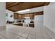 Bright kitchen with tile countertops, wood cabinets, and white appliances under a skylight at 781 Bourbon St # 1, Pahrump, NV 89048