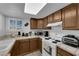 Compact kitchen featuring white appliances, tile countertops, and ample counter space at 781 Bourbon St # 1, Pahrump, NV 89048