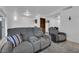 Open-concept living room with tile flooring, comfortable seating, and access to kitchen and backyard at 781 Bourbon St # 1, Pahrump, NV 89048