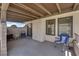 Covered patio with chairs, brick accents, and a sliding glass door at 781 Bourbon St # 1, Pahrump, NV 89048