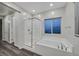 Bright bathroom featuring a glass shower, separate tub, and modern finishes at 786 Etter Creek St, Las Vegas, NV 89138