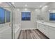 Modern bathroom with a soaking tub, walk-in shower, and dual sink vanity at 786 Etter Creek St, Las Vegas, NV 89138