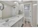 Bathroom with dual sinks, white cabinets, and a tub with shower at 786 Etter Creek St, Las Vegas, NV 89138