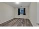 Bright bedroom featuring window, dark curtains, and laminate flooring at 786 Etter Creek St, Las Vegas, NV 89138