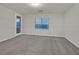 Large bedroom featuring soft carpeting, a window, and a glass paneled door at 786 Etter Creek St, Las Vegas, NV 89138