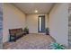 Modern, covered front porch with a bench and tile flooring at 786 Etter Creek St, Las Vegas, NV 89138