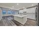 Beautiful kitchen featuring an island with a sink, stainless steel appliances, and an open living area at 786 Etter Creek St, Las Vegas, NV 89138