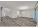 Bright living area with modern gray wood flooring and a contemporary chandelier at 786 Etter Creek St, Las Vegas, NV 89138