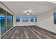 Bright living room featuring wood floors, large windows and a ceiling fan at 786 Etter Creek St, Las Vegas, NV 89138