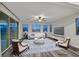 Staged living room featuring a ceiling fan, a large window and a glass sliding door at 786 Etter Creek St, Las Vegas, NV 89138