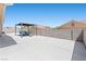View of the backyard with a concrete patio, outdoor seating and a block wall at 820 Peach Ave, North Las Vegas, NV 89032