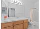 Bathroom featuring a sink, a large mirror, and a shower-tub combination at 820 Peach Ave, North Las Vegas, NV 89032