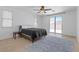 Bright bedroom features a ceiling fan, neutral decor, and sliding glass doors leading to a private outdoor space at 820 Peach Ave, North Las Vegas, NV 89032