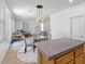 Bright dining area featuring stylish light fixture, chairs, and an inviting view of the living space at 820 Peach Ave, North Las Vegas, NV 89032