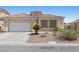 Lovely single-story house displaying desert landscaping, attached garage, and a well maintained front yard at 820 Peach Ave, North Las Vegas, NV 89032