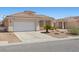 Charming single-story home featuring a two-car garage, low maintenance landscaping, and a tile roof at 820 Peach Ave, North Las Vegas, NV 89032