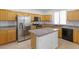 Functional kitchen showcasing tile backsplash, stainless steel appliances, and a central island at 820 Peach Ave, North Las Vegas, NV 89032