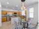 Well-lit kitchen and dining area featuring tile floors, stainless steel appliances, and wooden cabinets at 820 Peach Ave, North Las Vegas, NV 89032