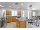 Bright kitchen featuring a center island, stainless steel appliances, and tile flooring at 820 Peach Ave, North Las Vegas, NV 89032