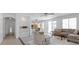 Bright living room featuring gray tile floors, neutral paint, and view into the dining area and kitchen at 820 Peach Ave, North Las Vegas, NV 89032
