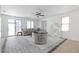 Open living room with gray tile floors, neutral walls, and sliding glass doors to the backyard at 820 Peach Ave, North Las Vegas, NV 89032