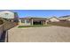 Backyard view of home with artificial turf and gravel at 832 Gallery Course Dr, Las Vegas, NV 89148