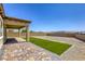 View of backyard with stone patio and low maintenance landscaping at 832 Gallery Course Dr, Las Vegas, NV 89148
