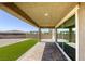 Covered patio in backyard with brick pavers and artificial turf at 832 Gallery Course Dr, Las Vegas, NV 89148