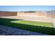 A backyard combines a grass area with gravel, and a brick-style floor offering a versatile outdoor living space at 832 Gallery Course Dr, Las Vegas, NV 89148