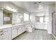 Spa-like bathroom featuring dual sinks, soaking tub, and tiled floors for ultimate relaxation at 832 Gallery Course Dr, Las Vegas, NV 89148