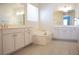 Bright bathroom with dual sinks, large soaking tub, and tile floors at 832 Gallery Course Dr, Las Vegas, NV 89148
