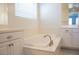 Large soaking tub with tile floors and dual vanities at 832 Gallery Course Dr, Las Vegas, NV 89148